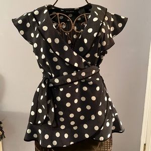 Black and white polka dot ruffled crossbody blouse